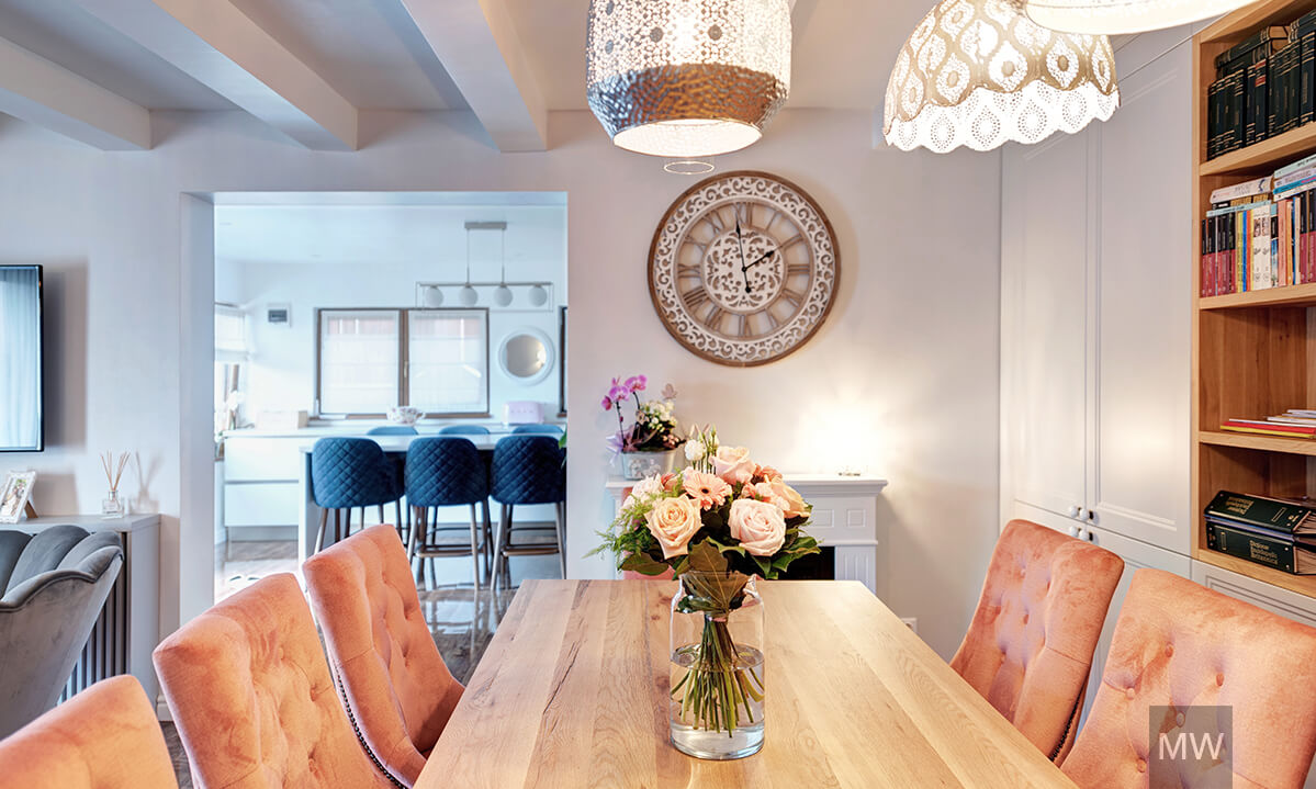 Dining room with kitchen in the background