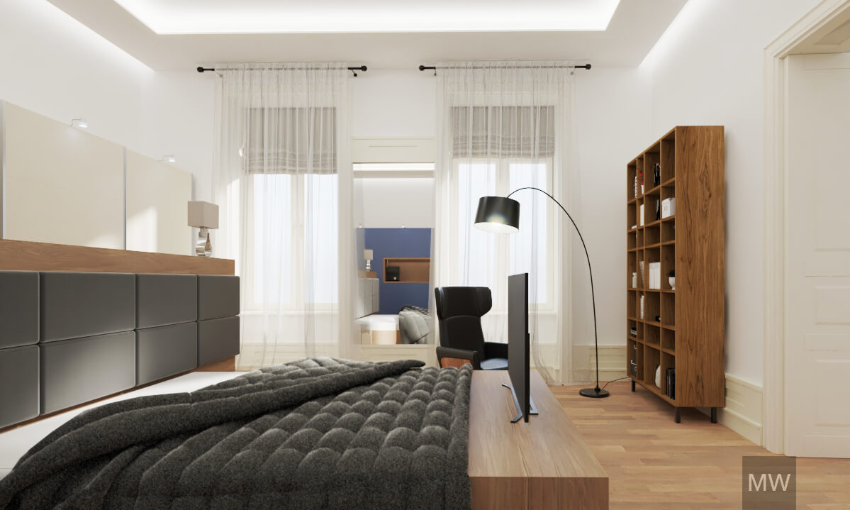 Large bedroom with big wardrobe behind the bed and reading corner