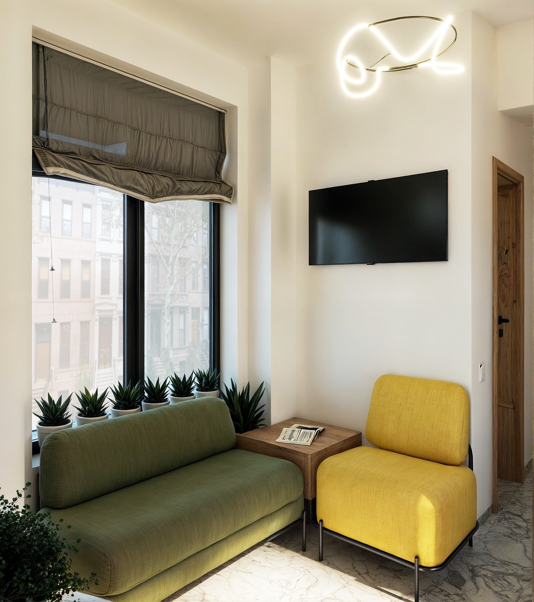 Green sofa and yellow chair combo in reception area